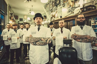 8 barbers in a traditional barbershop
